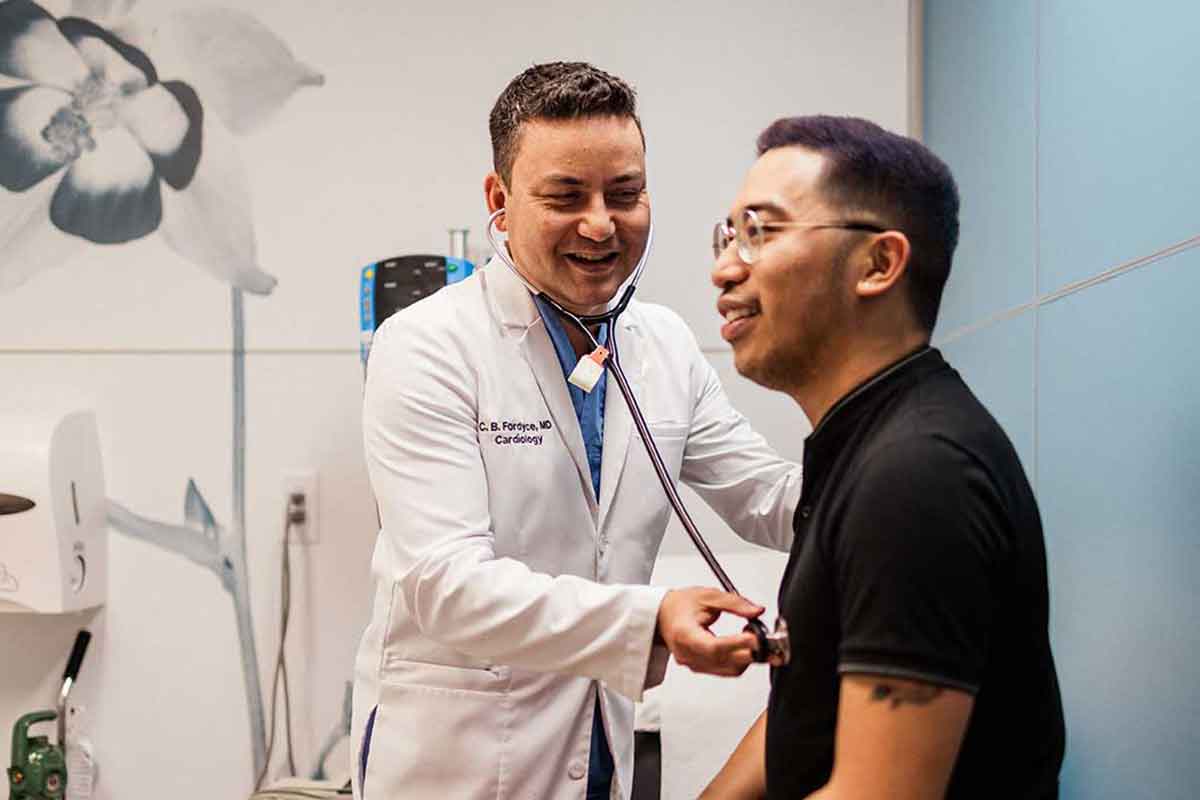 Cardiologist, Dr. Christopher Fordyce, is examining a young, male patient at the DCI Centre for Cardiac Critical Care